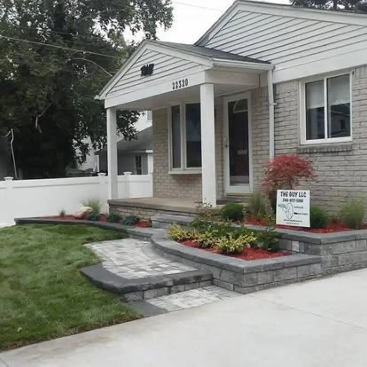 Segmental block retaining wall with paver steps and raised planting bed in Metro Detroit