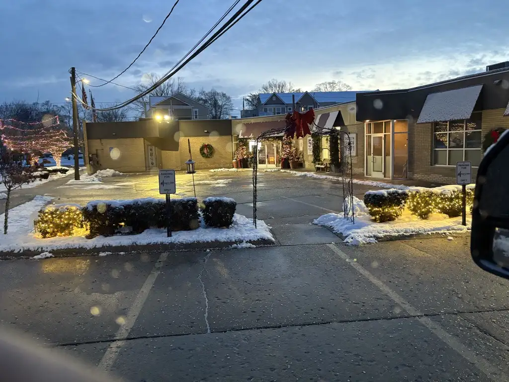 Cleared commercial sidewalk and entrance at dusk