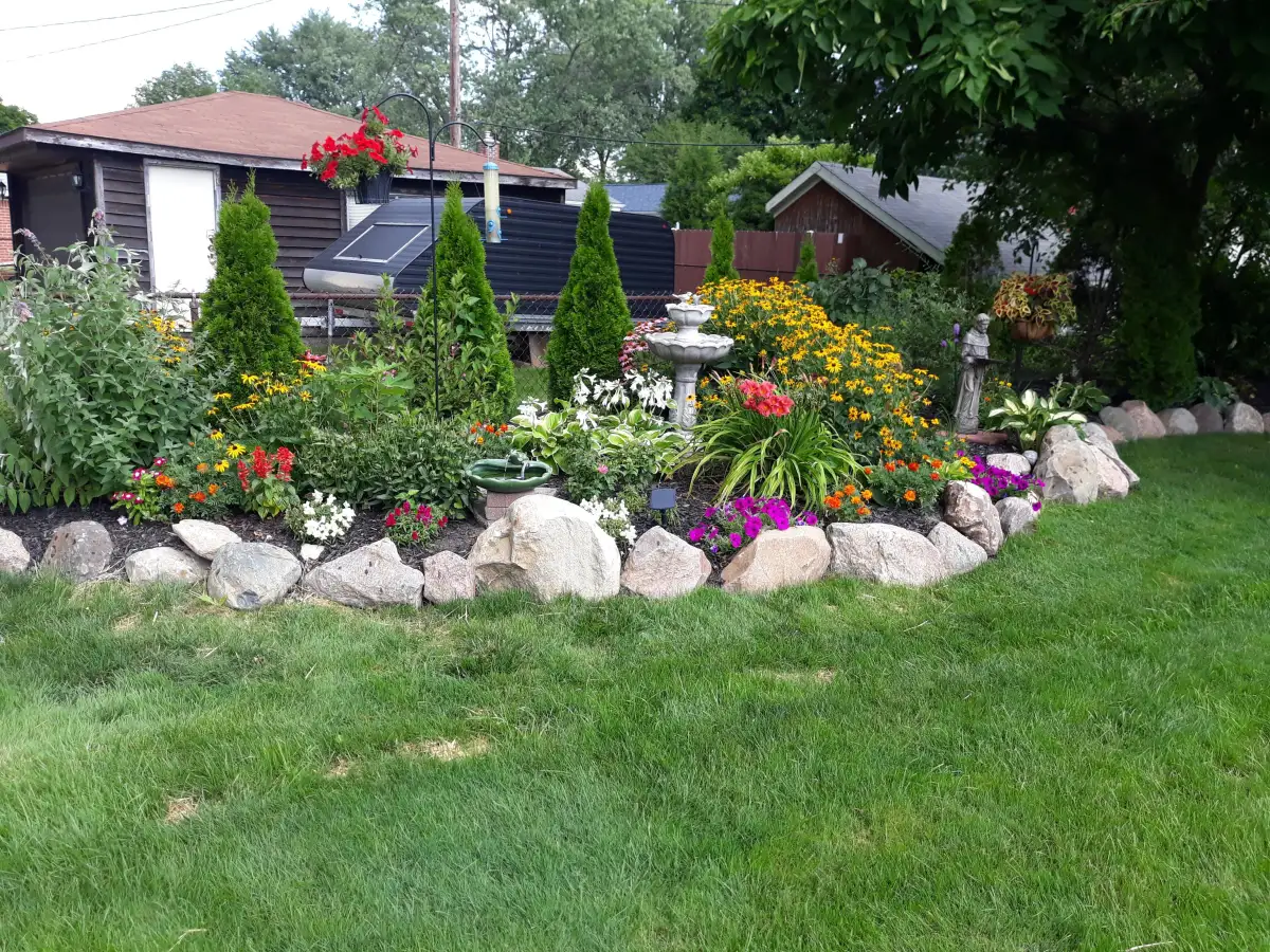 Colorful flower garden with boulder edging and ornamental plantings