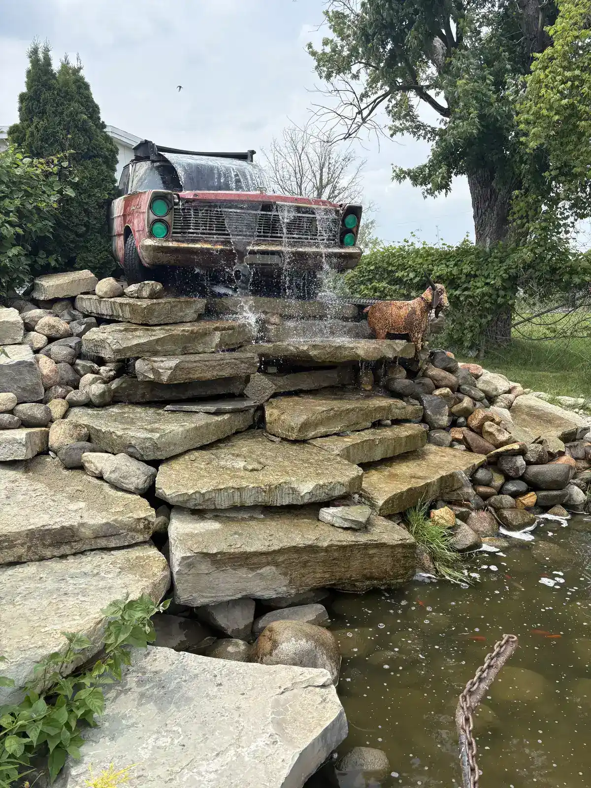 Residential pond with natural stone edging and water lilies