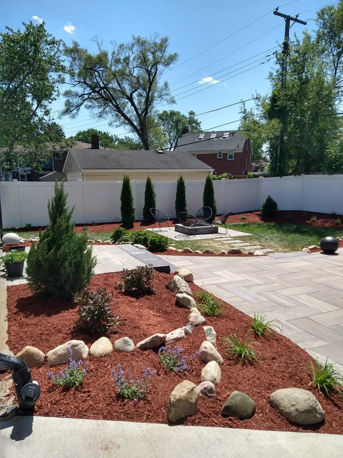 Custom landscape design and build project with paver patio and plantings in Metro Detroit