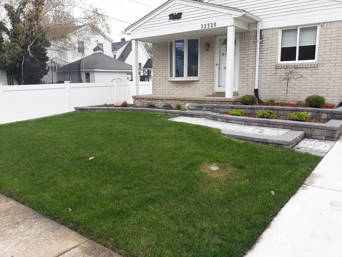 Finished residential lawn with layered landscape beds