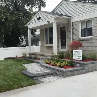 Finished lawn and planting bed beside a residential walkway