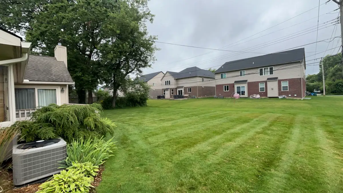 Professional lawn care with crisp mowing stripes on residential property
