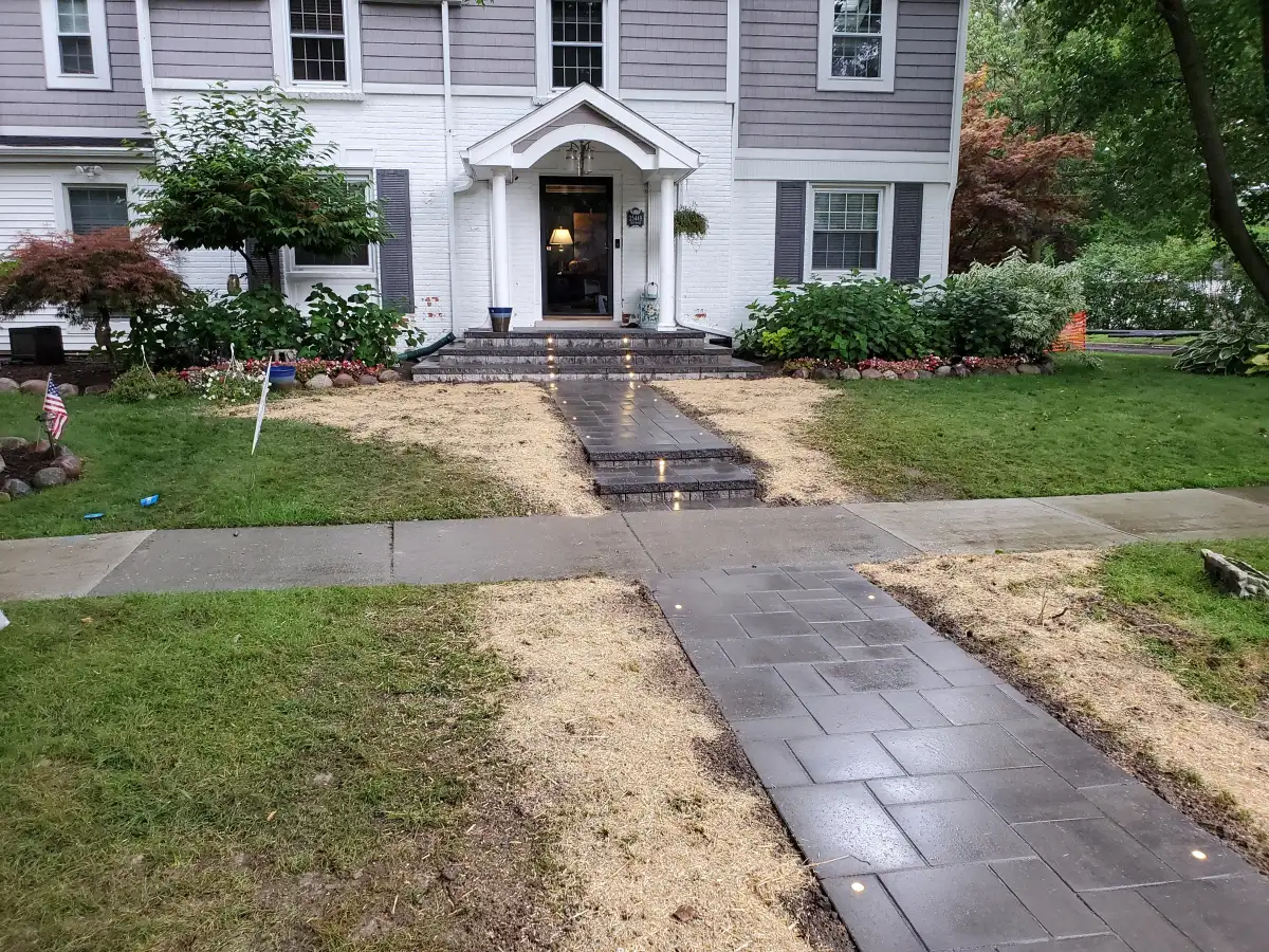 Curved retaining wall with landscape plantings along residential property