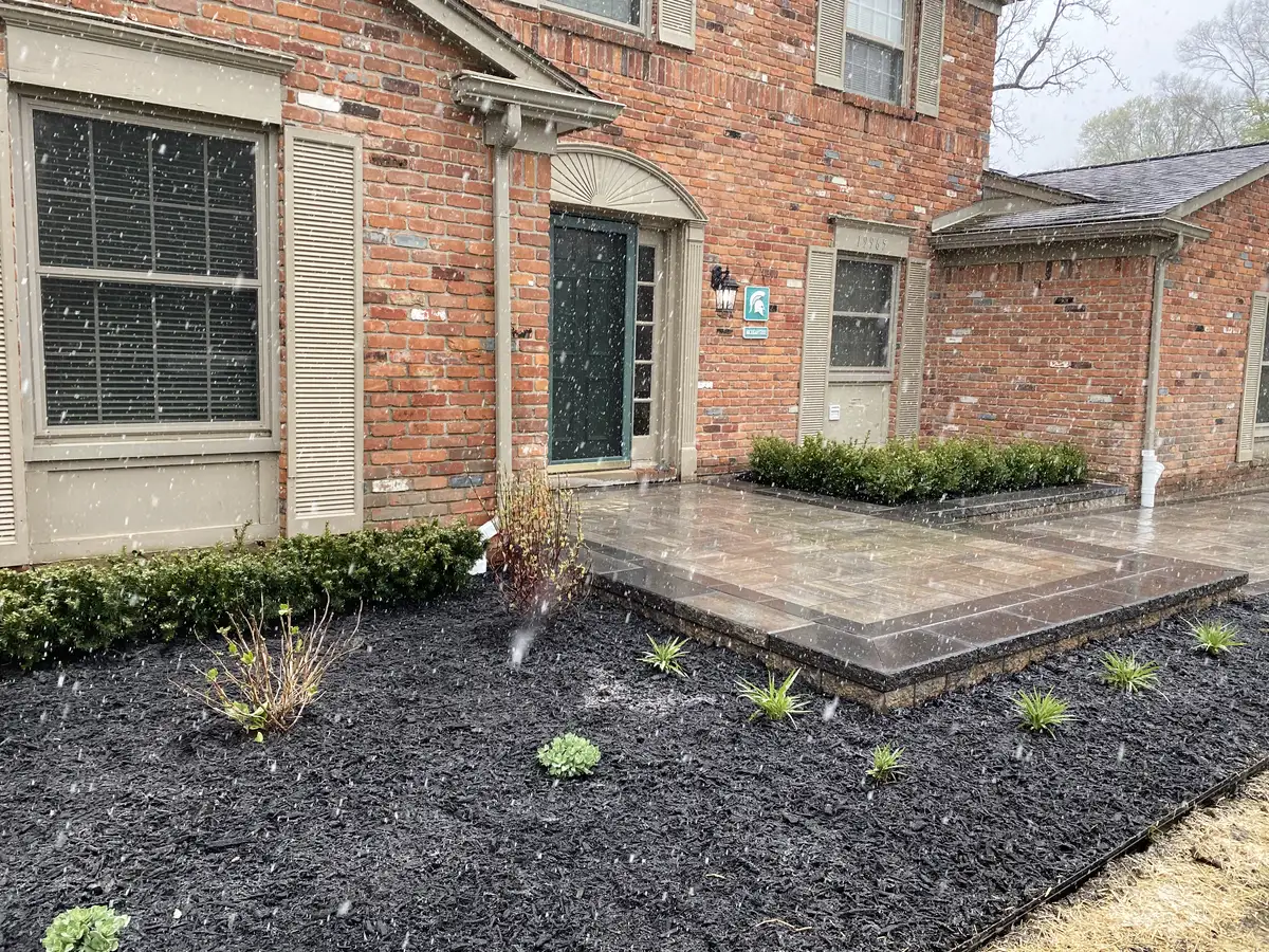 Brick paver patio installation complementing landscape design