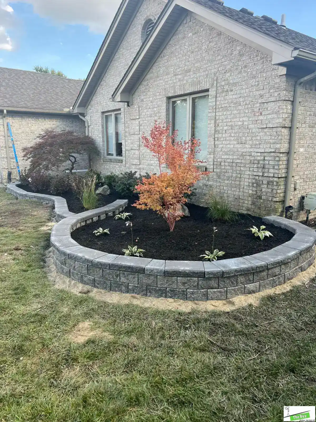 Engineered retaining wall with Japanese maple by The Guy Outdoor Services