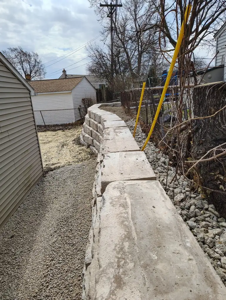 Cole residence retaining wall with garden beds and mature plantings