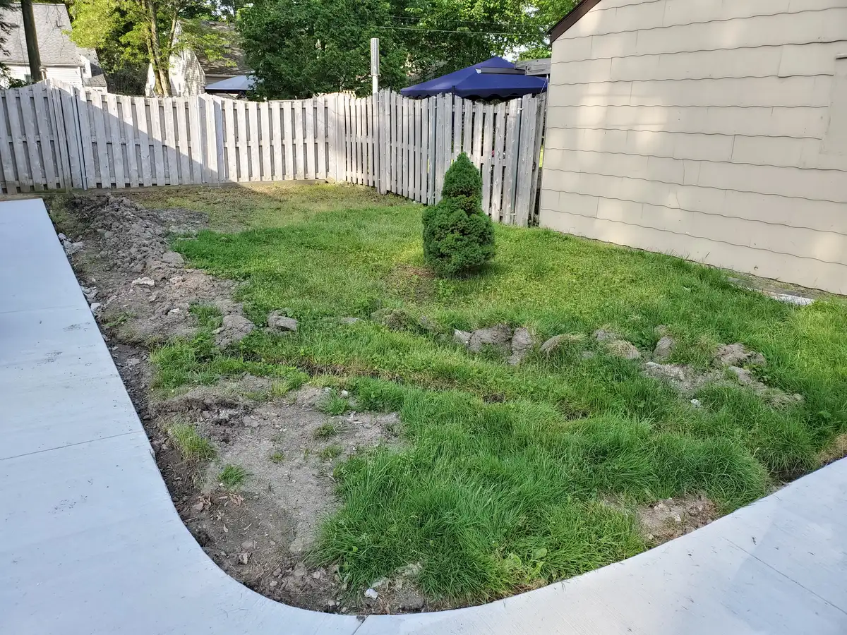 Crew installing fresh sod on graded soil in Metro Detroit