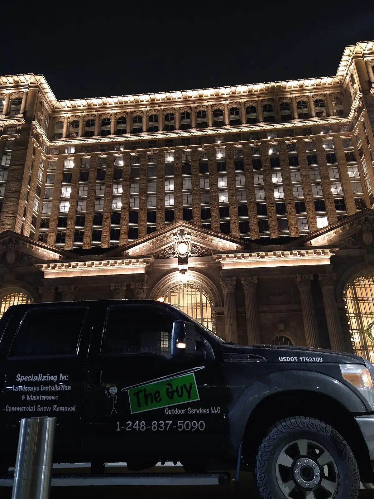 The Guy Outdoor Services branded truck at Michigan Central Station in Detroit