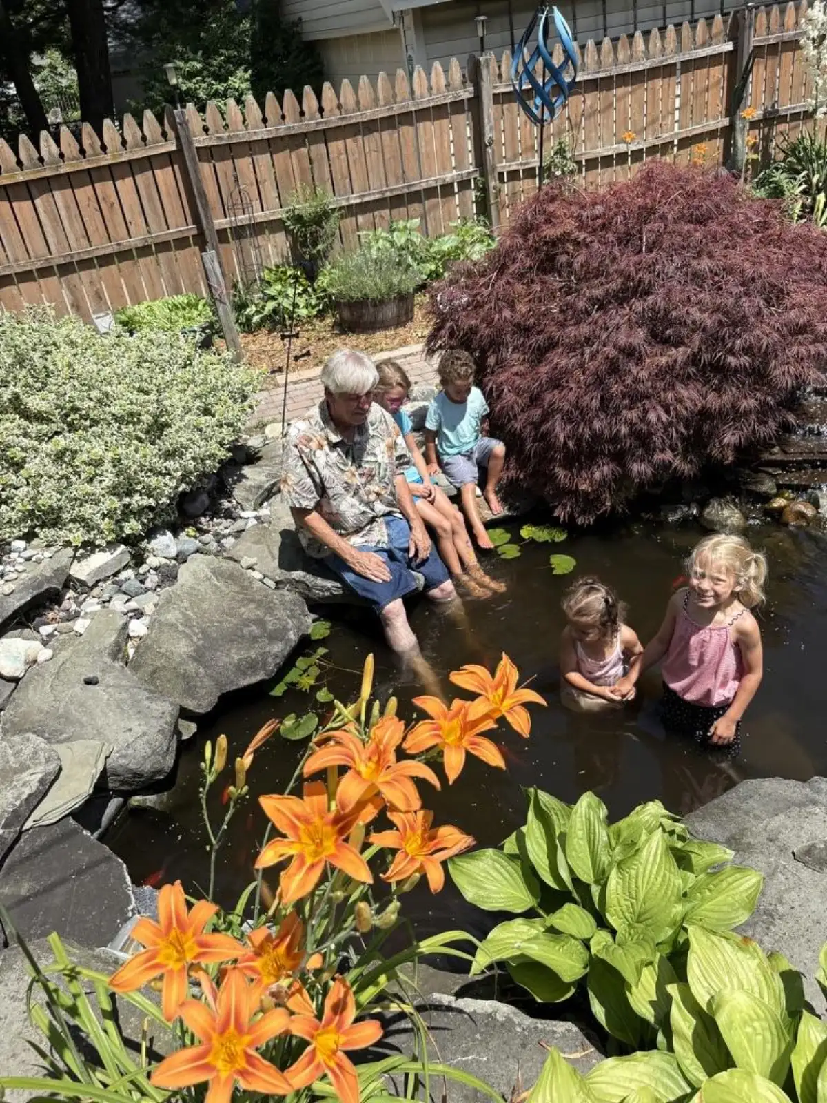 Vintage truck waterfall feature operating in winter with ice formations at sunset