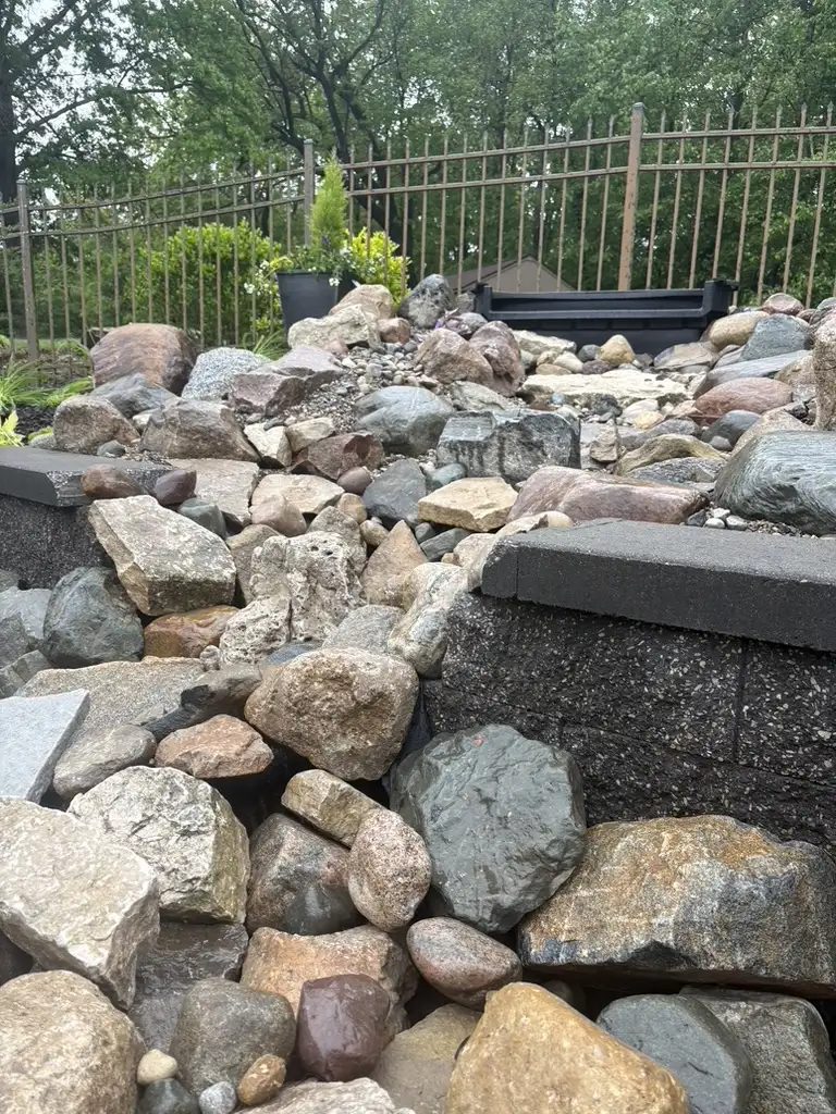 Natural stream bed with stone edges and ornamental grasses