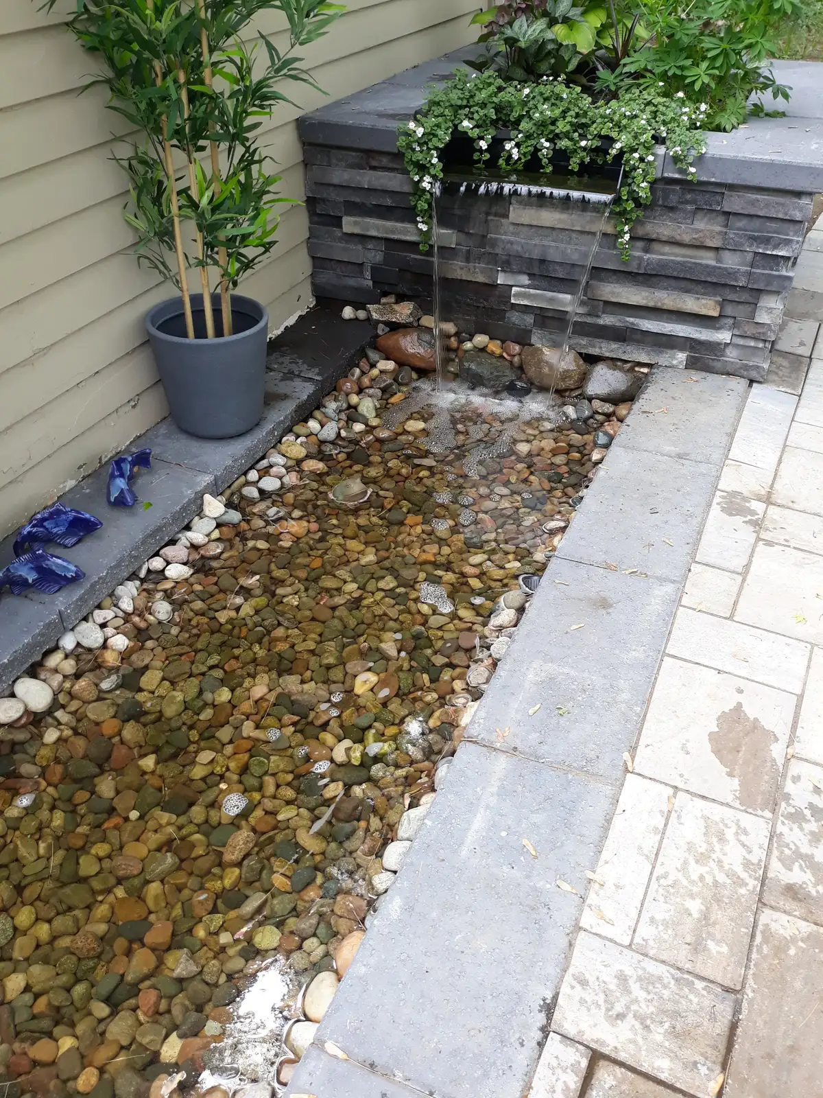 Meandering stream feature flowing through landscape beds in Sterling Heights